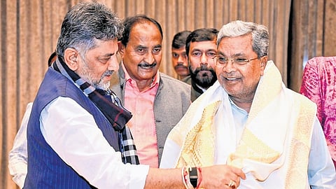 Deputy Chief Minister DK Shivakumar greets CM Siddaramaiah ahead of the Congress Legislature Party meeting in Bengaluru on Wednesday.