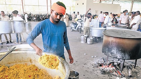 Cooks use firewood to prepare food at Freedom Park on Thursday.