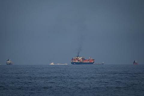 Oil tankers and cargo ships line up in the Strait of Hormuz as seen from Khor Fakkan, United Arab Emirates, Wednesday, March 11, 2026