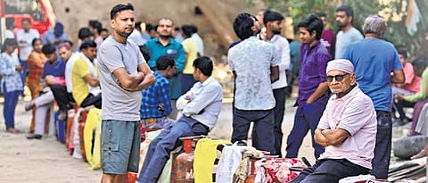 People queue up to avail LPG cylinders amid supply crisis in Prayagraj on Friday