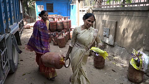 Two women carry a domestic LPG cylinder amid the ongoing situation in New Delhi.