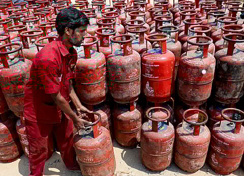 A worker arranges LPG cylinders at a distribution centre, amid supply crisis in the country, in Bengaluru, Karnataka, Saturday, March 14, 2026.