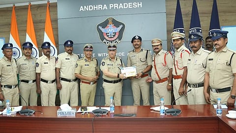 Prakasam SP Harshavardhan Raju receiving the Prestigious State level Award for the Best Crime Detection from DGP Harish Kumar Gupta at the police headquarters in Mangalagiri on Friday.