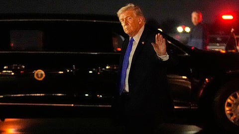 US President Donald Trump waves after arriving on Air Force One, Friday, March 13, 2026, at Palm Beach International Airport in West Palm Beach, Fla.