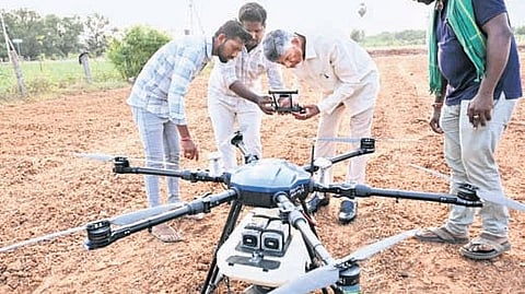Chief Minister N Chandrababu Naidu examines the functioning of an agricultural drone at Surampalli in Krishna district on Friday.