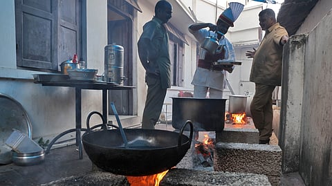 Workers cook on a wood-fired stove at the Indian Coffee House at Van Rose Junction in Thiruvananthapuram on Thursday following a shortage of LPG cooking gas.