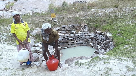 Due to lack of drinking water, residents of K Pudur village in Kachirayanpatti walk for over 2 km to Aruvimalai natural spring and fetch water.