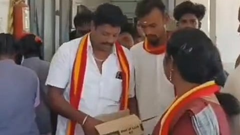 TVK party members donating stationery items to Class 10 students at the Government Higher Secondary School in Malumichampatti.