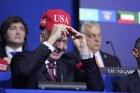 Giovanni Vincenzo Infantino, president of FIFA, tries out a USA hat during a Board of Peace meeting at the US Institute of Peace