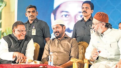 Chief Minister A Revanth Reddy with Minorities Welfare Minister Mohammad Azharuddin and AIMIM chief Asaduddin Owaisi at the Dawat-e-Iftar at LB Stadium in Hyderabad on Sunday.