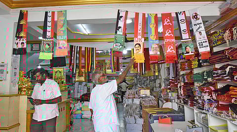 Political parties' flags and shawls are displayed for sale for the Assembly election campaign in TN
