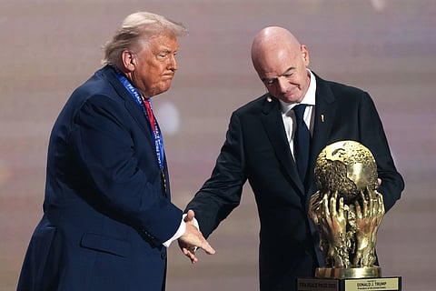 FIFA President Gianni Infantino presents President Donald Trump with the FIFA Peace Prize during the draw for the 2026 soccer World Cup at the Kennedy Center in Washington, Friday, December. 5, 2025.