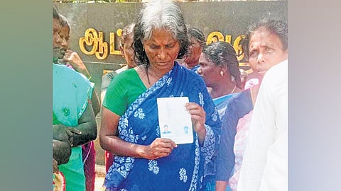 P Kaliammal, wife of M Petchimuthu, with his passport on Monday