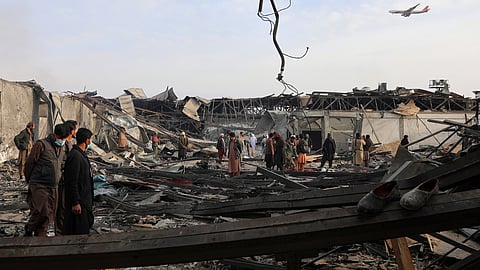 Residents and volunteers inspect the site of a late-Monday airstrike at a drug rehabilitation hospital in Kabul, Afghanistan, Tuesday, March 17, 2026.