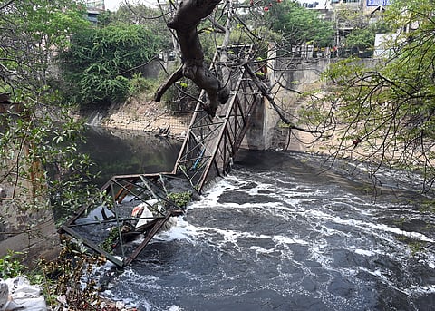 A view of the site where a 60-foot iron overbridge collapsed in Roop Nagar on Tuesday morning, killing a woman who fell into the drain below.