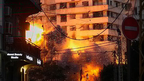 An explosion erupts from a building following an Israeli strike in central Beirut, Lebanon, Wednesday, March 18, 2026.