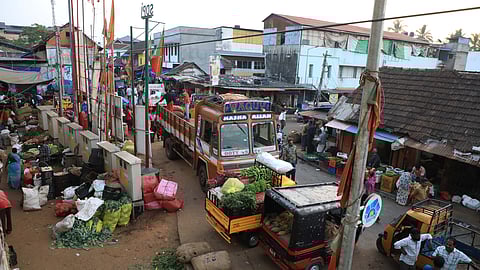 It is a busy scene in the mornings at Chalai, which also means the narrow road stretch gets clogged as loading and unloading brisks up.