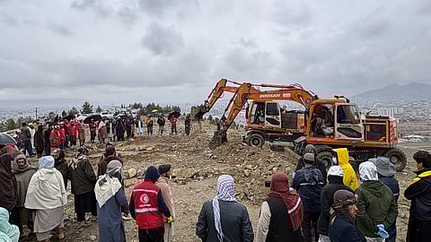 Bulldozers dig graves for victims of a Pakistani airstrike on a drug rehabilitation hospital in Kabul, Afghanistan, Wednesday, March 18, 2026.