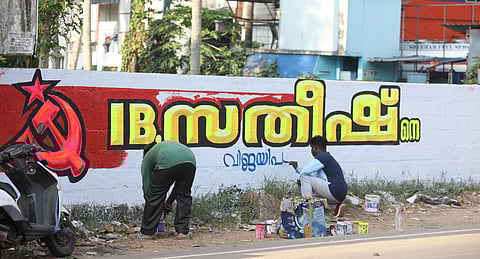 LDF workers paint a wall in support of I. B. Satheesh in the Kattakada Assembly constituency of Thiruvananthapuram ahead of the upcoming elections.