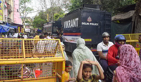 Police vehicles and barricades deployed as part of security arrangements ahead of Eid al-Fitr, at Uttam Nagar, in New Delhi, Thursday, March 19, 2026. As per the officials, tension prevails in the area following murder case of Tarun.