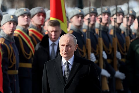 Russian President Vladimir Putin attends a wreath-laying ceremony at the Tomb of the Unknown Soldier near the Kremlin Wall during the national celebration of "Defender of the Fatherland Day" in Moscow, Russia, Feb. 23, 2026.