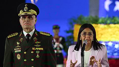 Venezuela's Vice-President Delcy Rodriguez (R) speaks next to Venezuelan Defence Minister General Vladimir Padrino Lopez during a military parade at the inauguration of Victory Square, commemorating the 80th anniversary of the Soviet Union's victory over Nazi Germany in World War Two (WWII), in Caracas on May, 13, 2025.