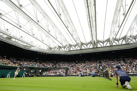 Marketa Vondrousova of the Czech Republic plays a backhand return to Jessica Bouzas Maneiro of Spain on Centre Court during their first round match at the Wimbledon tennis championships in London, July 2, 2024.