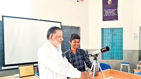 Md Javed, a Hindi teacher at the Government High School in Savaran, explains
the working principle of a telescope to his student, Syed Hanif.
