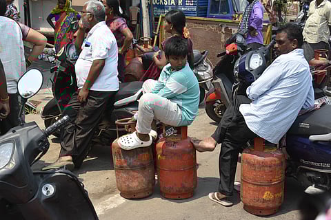 People throng a gas distribution office for refill in Vijayawada on Friday.