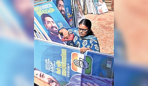 K Bindu works on election campaign materials at Olavanna.