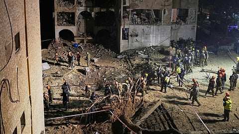 Israeli security forces and rescue teams work at the site struck by an Iranian missile in Arad, southern Israel, Sunday, March 22, 2026.