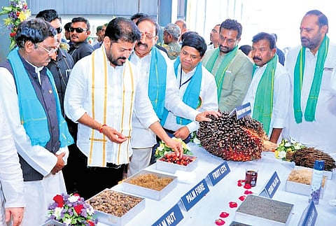 Chief Minister A Revanth Reddy looks at farm products after inaugurating a palm oil factory at Narmetta in Siddipet district on Sunday.