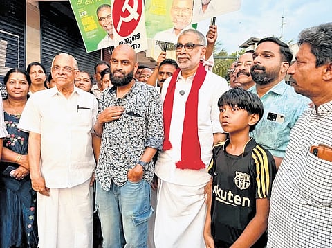 LDF candidate Saju Paul poses with voters