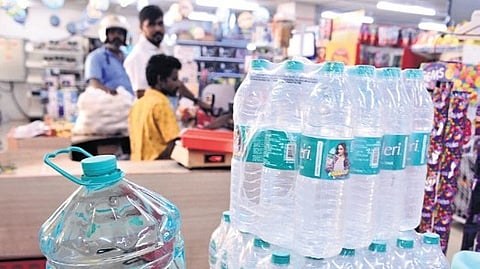 Stacks of packaged drinking water cans piled up at a supermarket in Chennai, as prices rise across state.