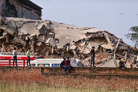 People gather as a rescue operation is underway after a cold storage building collapsed, at Phaphamau, in Prayagraj district, Uttar Pradesh, Monday, March 23, 2026. At least 20 people were feared trapped under debris even as rescue operations were under way.