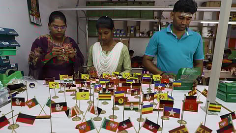 Workers busy making Political party flags which is used inside the car dashboards at a unit at Selakarachal village in Coimbatore district.