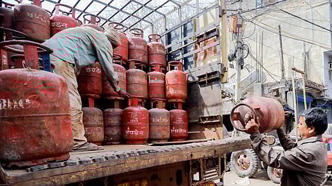 Workers load LPG cylinders amid a reported ongoing LPG supply shortage in New Delhi on March 14, 2026.