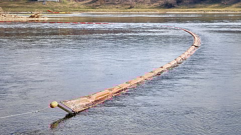 Chemical absorbent booms are placed in the Dniester river in Curesnita, Moldova, on the border with Ukraine, Tuesday, March 17, 2026.