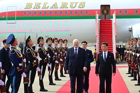 In this photo released by Belarus' Presidential Press Service, Belarusian President Alexander Lukashenko, center, arrives to the Pyongyang International Airport, outside Pyongyang, North Korea, Wednesday, March 25, 2026.