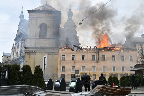 Fire and smoke raises above the city center following Russia's drone attack in Lviv, Ukraine, Tuesday, March 24, 2026.