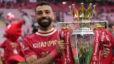 Liverpool's Mohamed Salah poses with the winner's trophy after the English Premier League soccer match between Liverpool and Crystal Palace at the Anfield stadium in Liverpool, England, May 25, 2025.