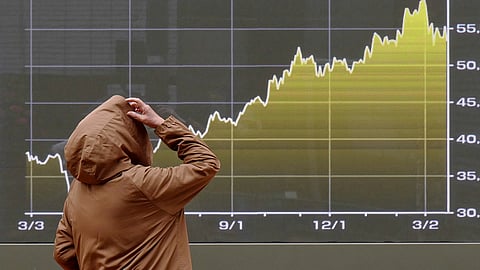 A person looks at an electronic stock board showing Japan's Nikkei index chart at a securities firm Monday, March 23, 2026, in Tokyo.