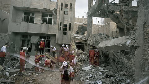 First responders inspect the remains of a residential building hit in an overnight strike during the U.S.-Israeli military campaign in Tabriz, East Azerbaijan Province, northwestern Iran, Tuesday, March 24, 2026.