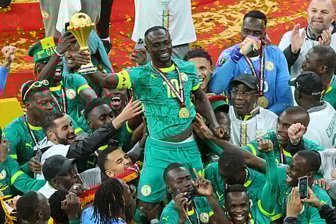Senegal's Sadio Mane holds the trophy aloft as he celebrates with teammates after winning the Africa Cup of Nations final soccer match between Senegal and Morocco in Rabat, Morocco, Sunday, Jan. 18, 2026.