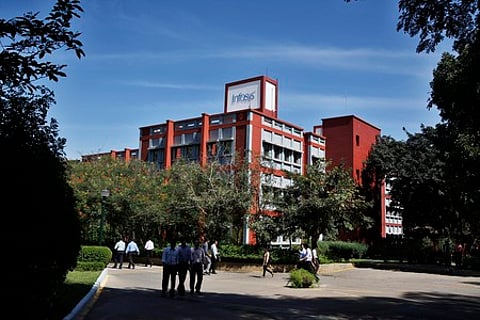 Infosys Technologies Ltd. employees walk inside the company's headquarters in Bengaluru