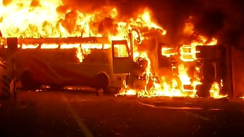 Flames billow from a private bus after it caught fire, in Rayavaram, Andhra Pradesh, Thursday, March 26, 2026.