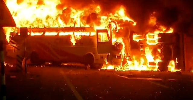Flames billow from a private bus after it caught fire, in Rayavaram, Andhra Pradesh, Thursday, March 26, 2026. At least 14 people were killed and 23 injured in the incident.