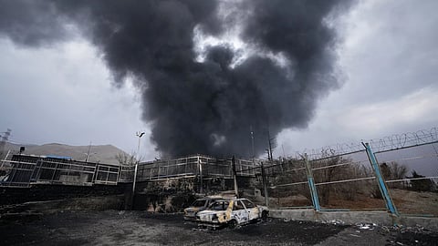 A thick plume of smoke rises from an oil storage facility hit by a US-Israeli strike in Tehran