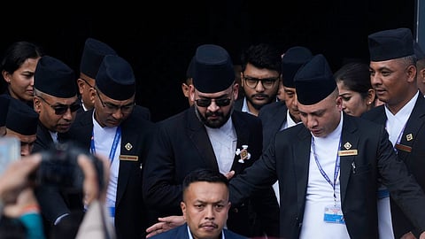 Balendra Shah, center with sun glasses, leaves after a swearing-in ceremony of newly elected members of the House of Representatives at the Federal Parliament in Kathmandu, Nepal, Thursday, March 26, 2026.