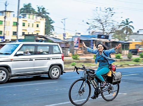 Sameera Khan pedals her way on a busy road in Bhubaneswar